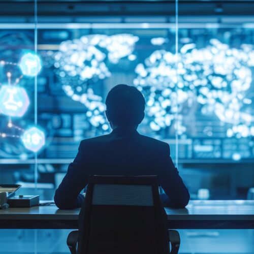 Abstract image showing person sitting at desk and looking at both physical and virtual computer screens