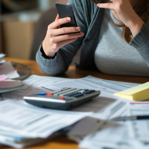 A photo of a stressed woman managing taxes on the phone with a tax advisor AI generated